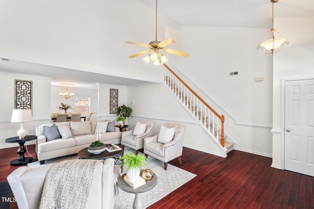 living area featuring stairway, high vaulted ceiling, visible vents, and wood finished floors