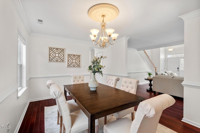 dining area featuring a wealth of natural light, ornamental molding, an inviting chandelier, and hardwood / wood-style floors