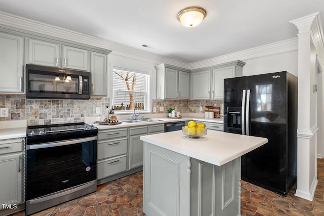 kitchen featuring tasteful backsplash, gray cabinets, stainless steel appliances, and stone finish flooring