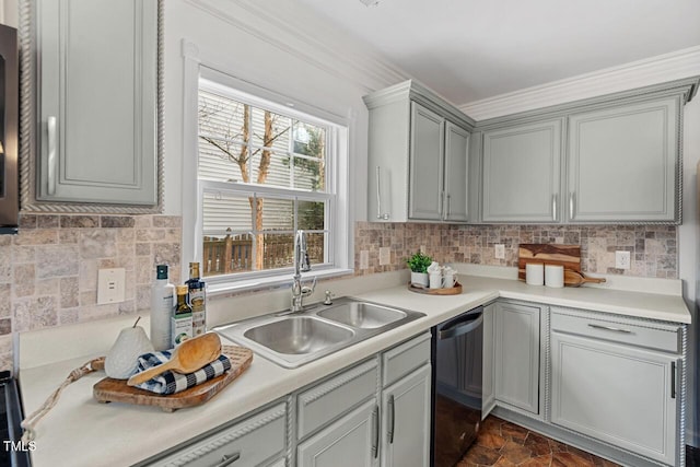 kitchen with stone finish floor, a sink, tasteful backsplash, light countertops, and dishwasher