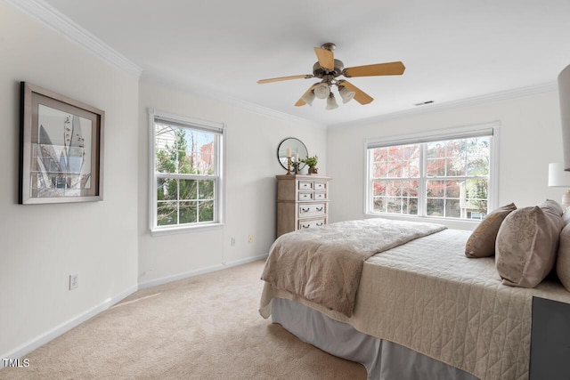 bedroom featuring visible vents, a ceiling fan, crown molding, baseboards, and light colored carpet