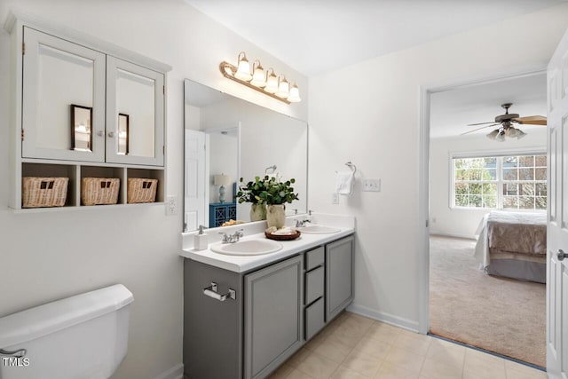 ensuite bathroom featuring ensuite bath, toilet, double vanity, and a sink