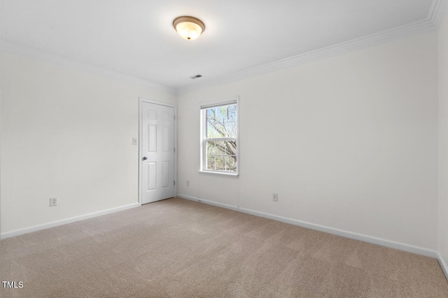 carpeted empty room featuring visible vents, baseboards, and crown molding