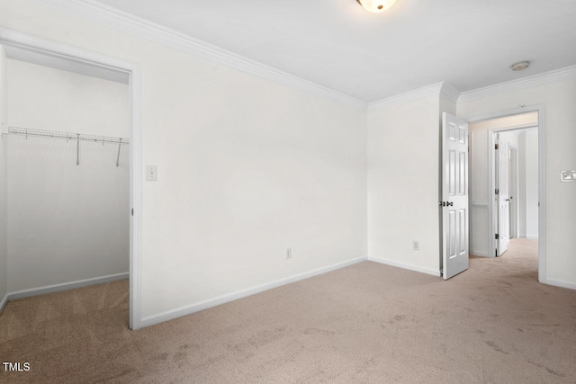 unfurnished bedroom with a closet, carpet flooring, baseboards, and ornamental molding