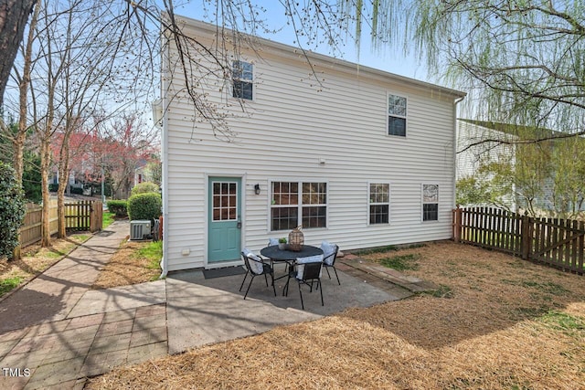 back of property with a patio, cooling unit, and a fenced backyard