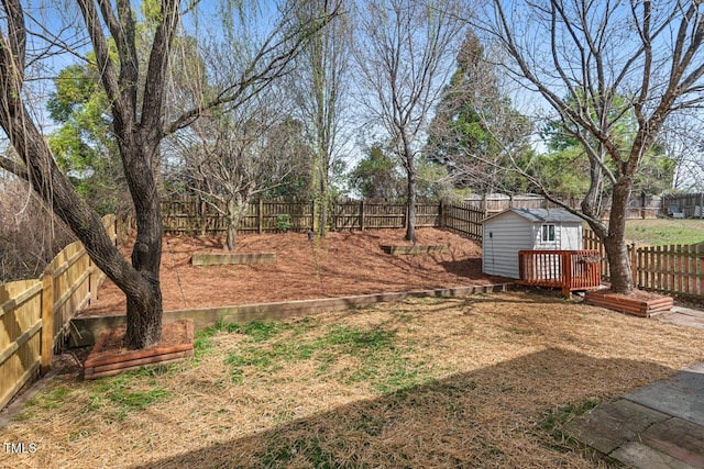 view of yard with a deck, an outdoor structure, and a fenced backyard