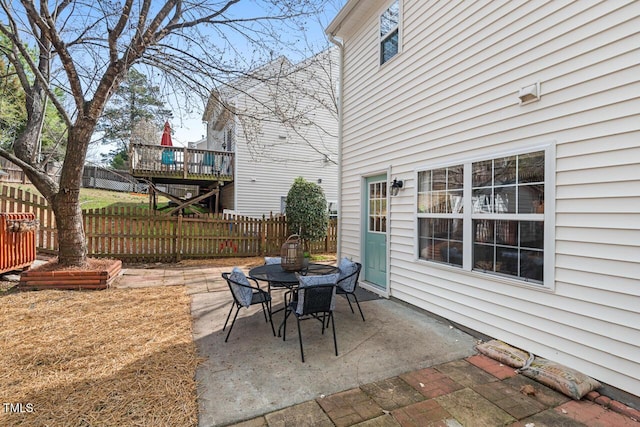 view of patio featuring outdoor dining area and fence