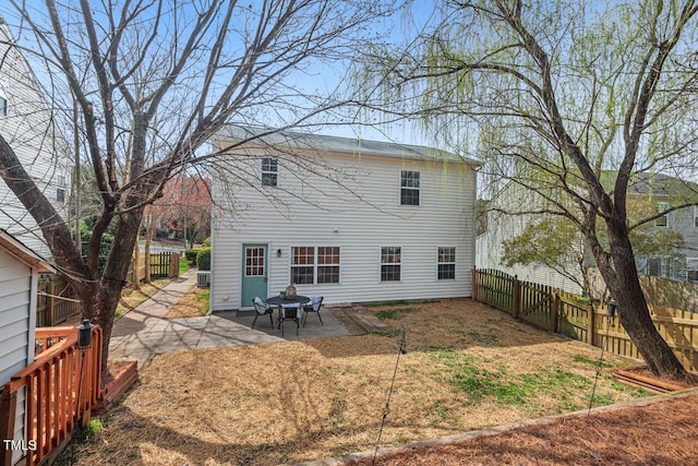 back of house with a patio area and a fenced backyard