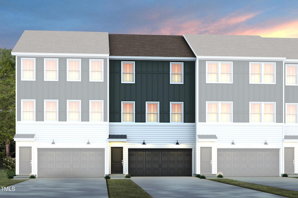 view of property with an attached garage and driveway