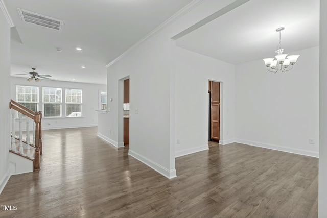 spare room featuring ceiling fan with notable chandelier, dark wood-style flooring, visible vents, baseboards, and stairs