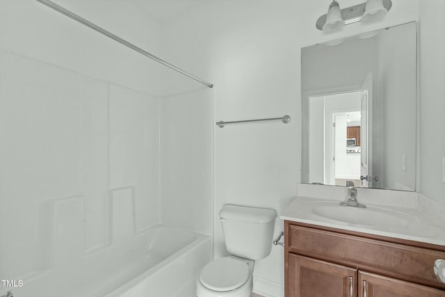 bathroom with tub / shower combination, vanity, and toilet