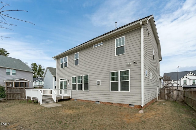 back of property with a deck, crawl space, and a fenced backyard