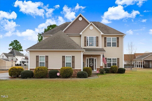 view of front of property with a front lawn, a shingled roof, and fence