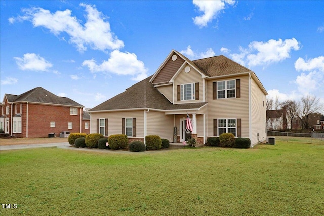 view of front of property with a shingled roof, fence, a front lawn, and central air condition unit