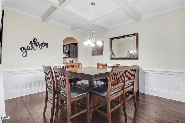 dining room with dark wood-type flooring, coffered ceiling, beam ceiling, and an inviting chandelier