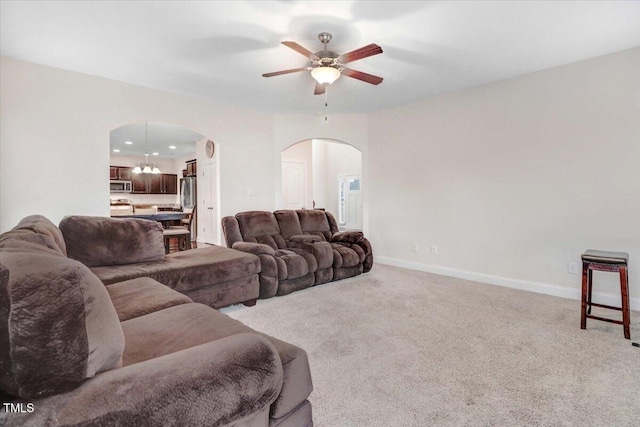 living room with baseboards, arched walkways, light colored carpet, ceiling fan, and recessed lighting