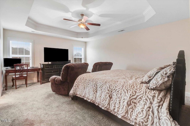 bedroom featuring a raised ceiling, carpet flooring, crown molding, and visible vents