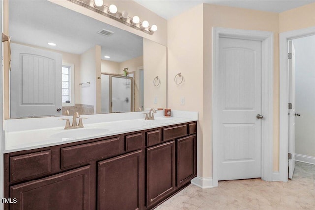 bathroom with double vanity, a stall shower, visible vents, and a sink