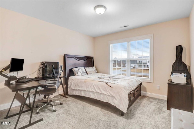 carpeted bedroom featuring visible vents and baseboards