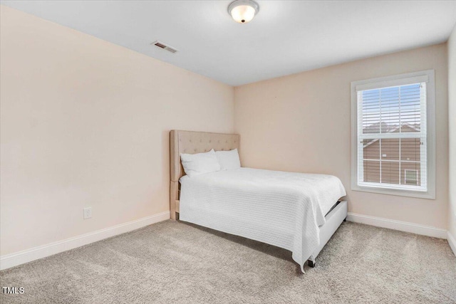 bedroom featuring carpet, visible vents, and baseboards