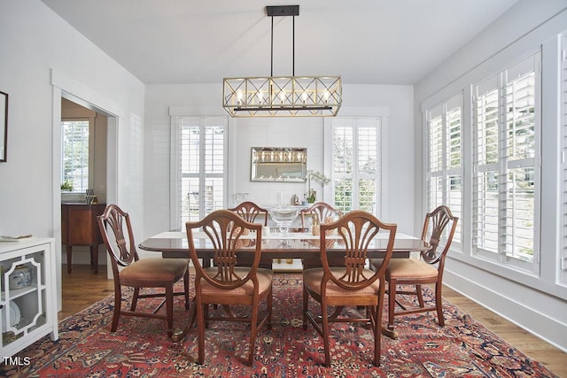 dining room with a wealth of natural light and wood finished floors