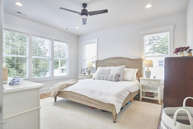 bedroom with light wood-type flooring, visible vents, ceiling fan, and recessed lighting