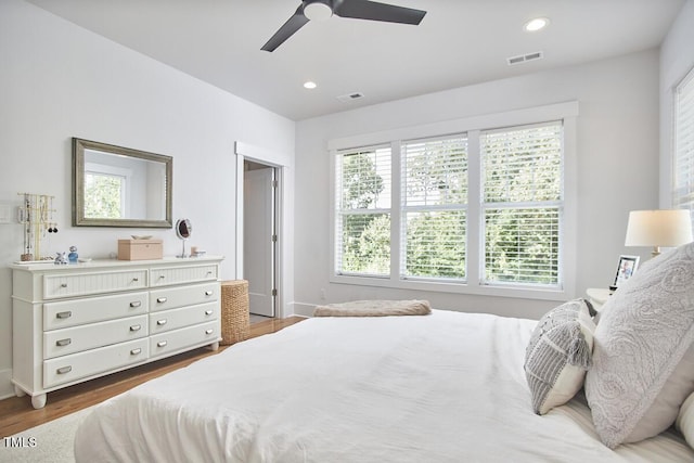 bedroom featuring recessed lighting, visible vents, baseboards, and wood finished floors