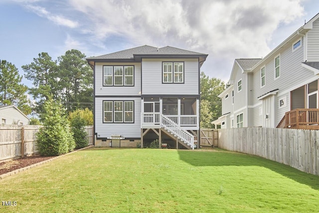 rear view of house with a yard, crawl space, a fenced backyard, and a sunroom