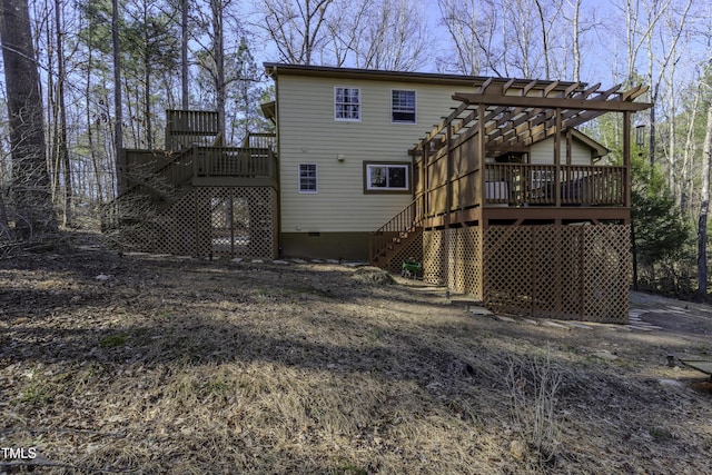 rear view of house featuring crawl space, stairway, a pergola, and a deck