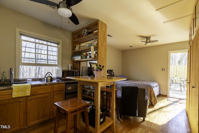 kitchen featuring brown cabinets, open shelves, a ceiling fan, and dark wood-style flooring