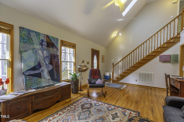 interior space featuring stairs, light wood-type flooring, visible vents, and ceiling fan