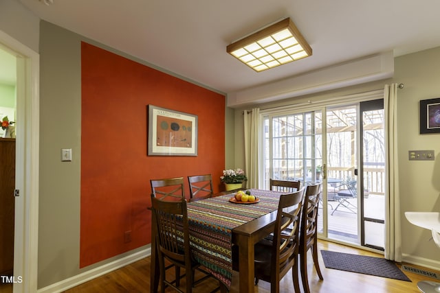 dining area with wood finished floors and baseboards