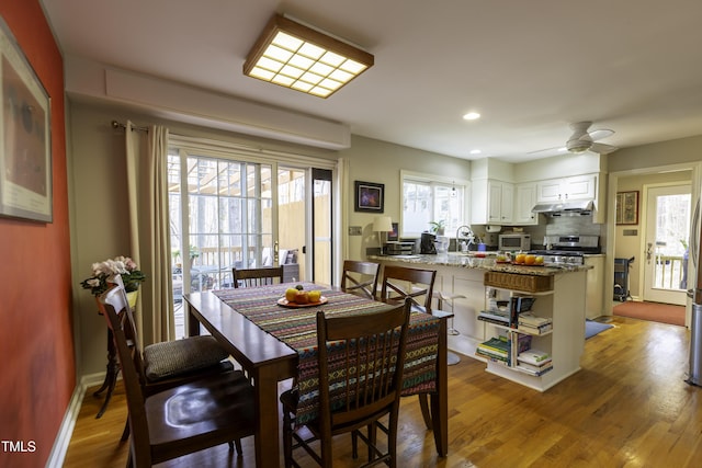 dining area featuring ceiling fan, baseboards, light wood-style flooring, and recessed lighting