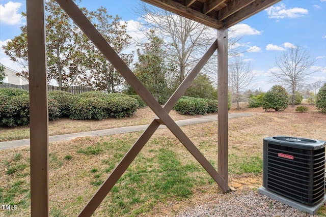 view of yard with fence and central AC unit