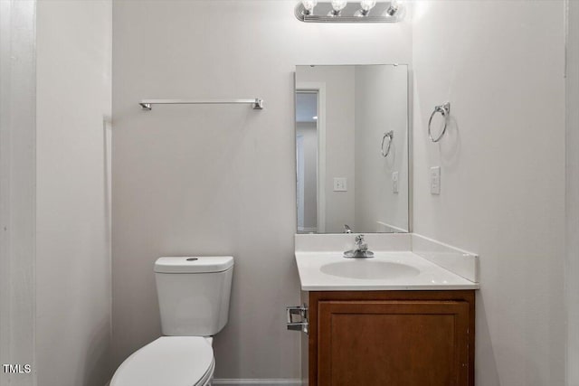 half bath featuring toilet and vanity