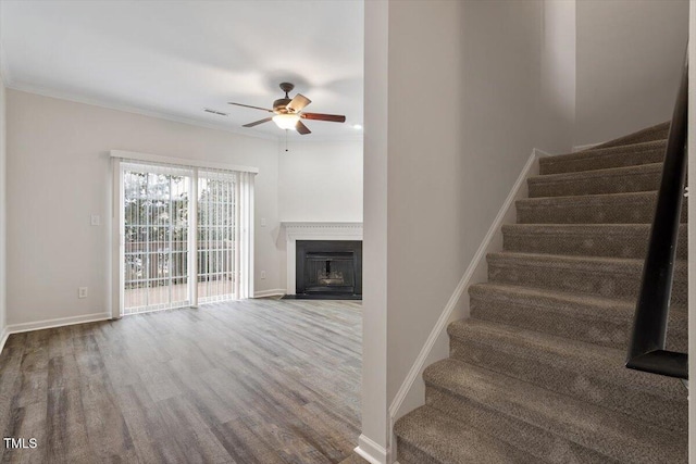 stairway featuring visible vents, baseboards, and wood finished floors