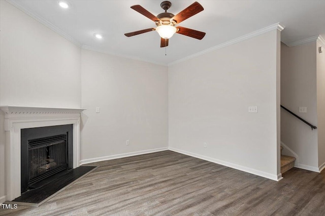 unfurnished living room featuring crown molding, stairway, baseboards, and wood finished floors