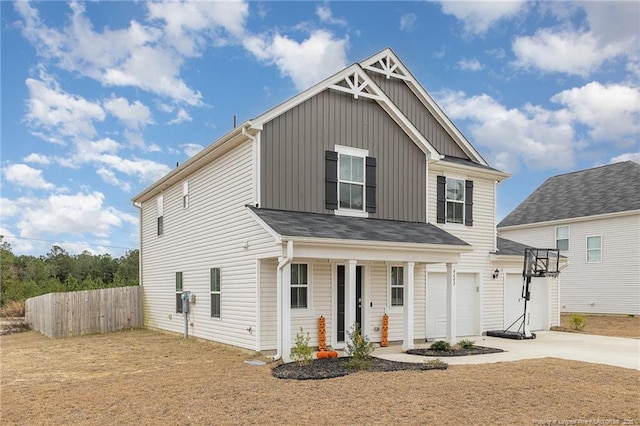 view of front of property featuring a garage, concrete driveway, and fence