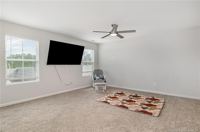 unfurnished room with carpet floors, baseboards, and a ceiling fan