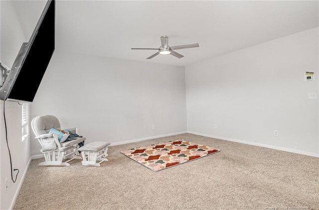 living area with carpet flooring, a ceiling fan, and baseboards