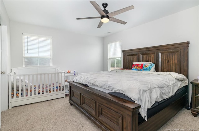 bedroom with light carpet and ceiling fan