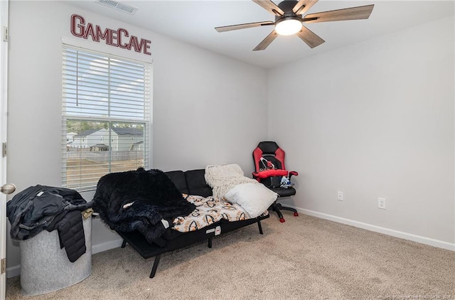 living area with a ceiling fan, carpet, visible vents, and baseboards