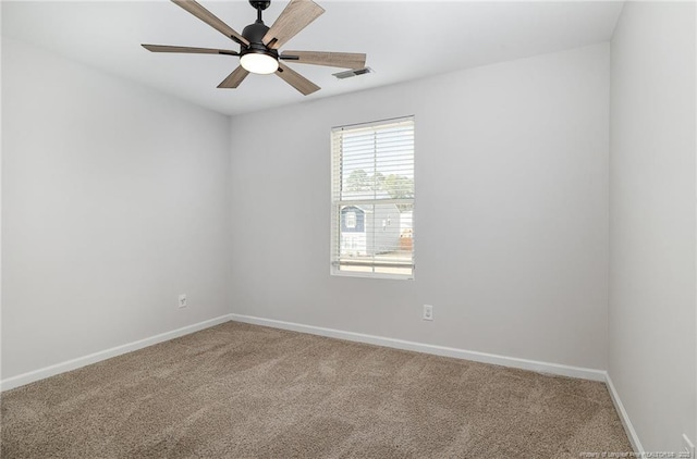 carpeted empty room with visible vents, ceiling fan, and baseboards