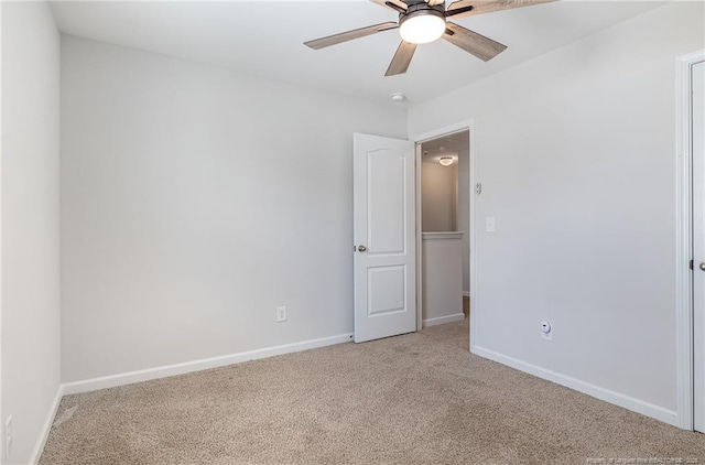 unfurnished room with ceiling fan, baseboards, and light colored carpet