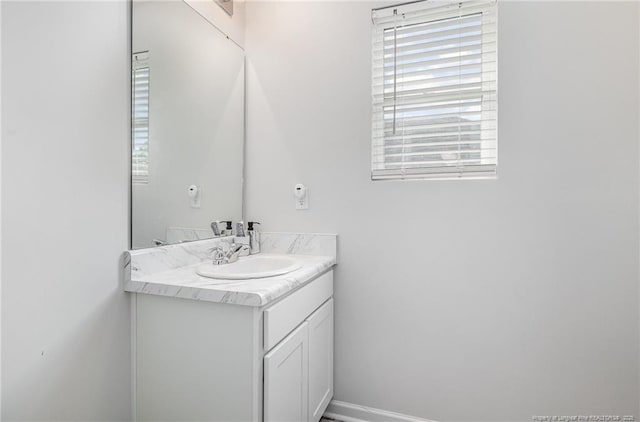 bathroom with vanity and baseboards