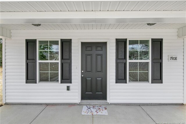 view of exterior entry with covered porch