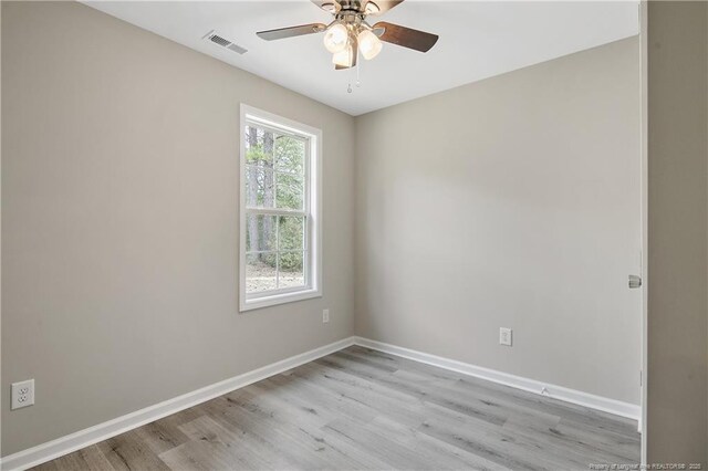 empty room featuring visible vents, baseboards, light wood-style floors, and a ceiling fan