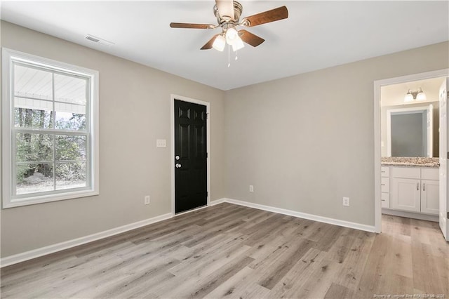 unfurnished room with light wood-style flooring, baseboards, and visible vents