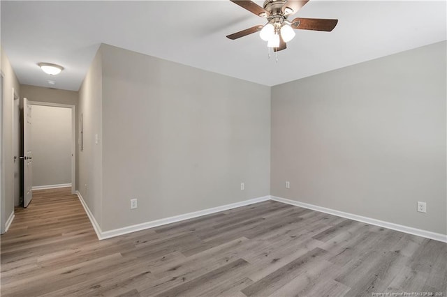 unfurnished room with ceiling fan, baseboards, and wood finished floors