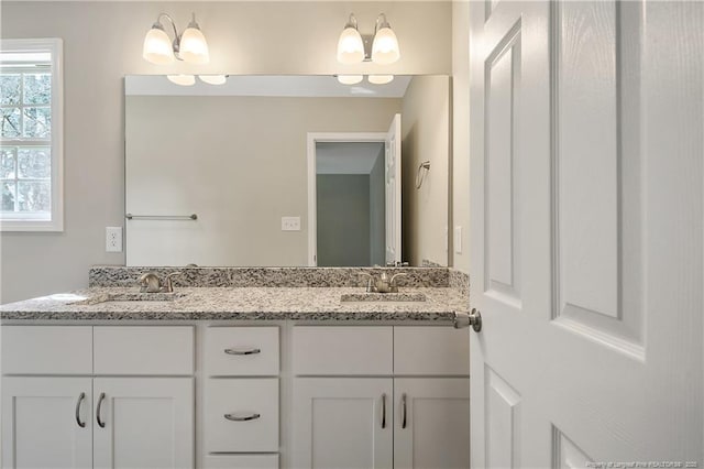 bathroom with a sink and double vanity